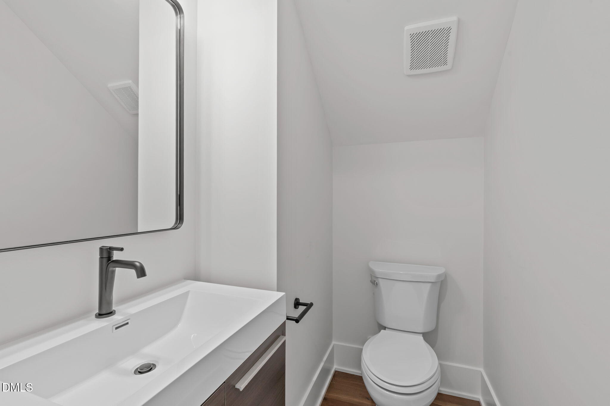 637 Conover Road, Unit B Durham, NC 27703 - Photo 13 of 52 a white toilet sitting next to a bathroom sink