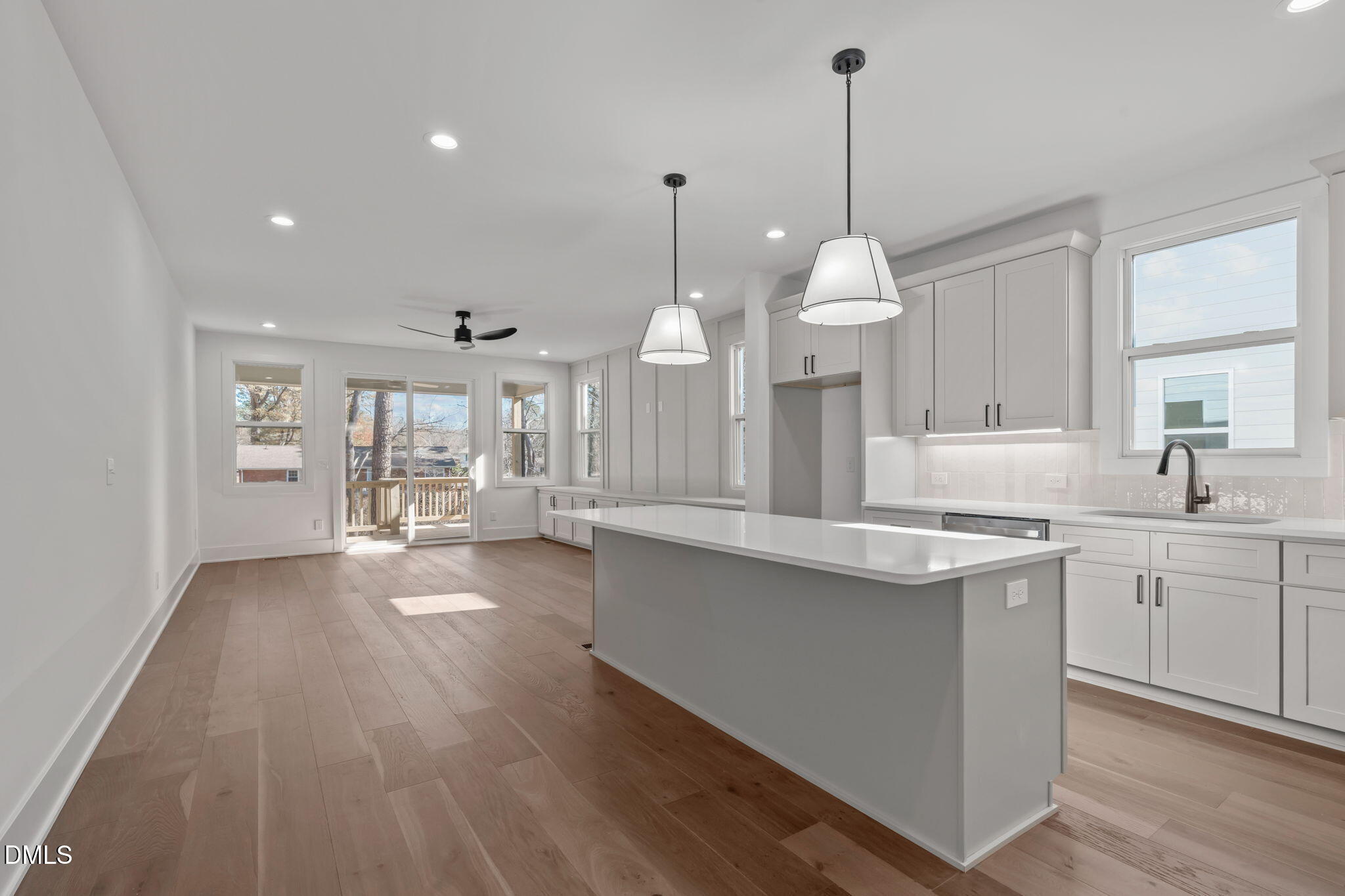 637 Conover Road, Unit B Durham, NC 27703 - Photo 14 of 52 a large kitchen with granite countertop a stove a sink a island and a wooden floors