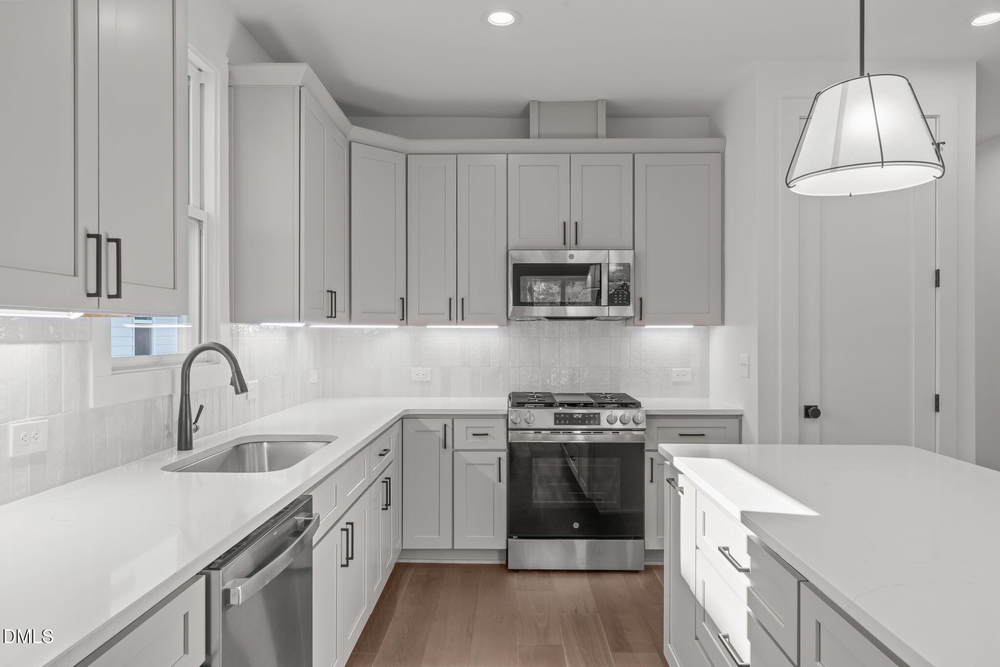 637 Conover Road, Unit B Durham, NC 27703 - Photo 16 of 52 a kitchen with stainless steel appliances a sink stove and cabinets