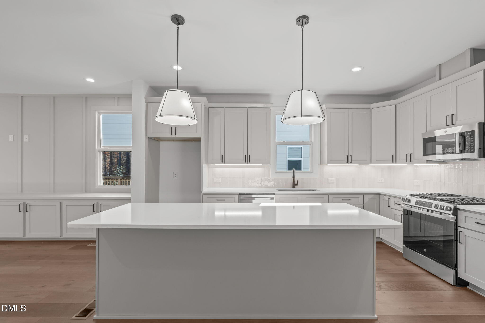 637 Conover Road, Unit B Durham, NC 27703 - Photo 23 of 52 a kitchen with kitchen island granite countertop a sink a counter space appliances and cabinets