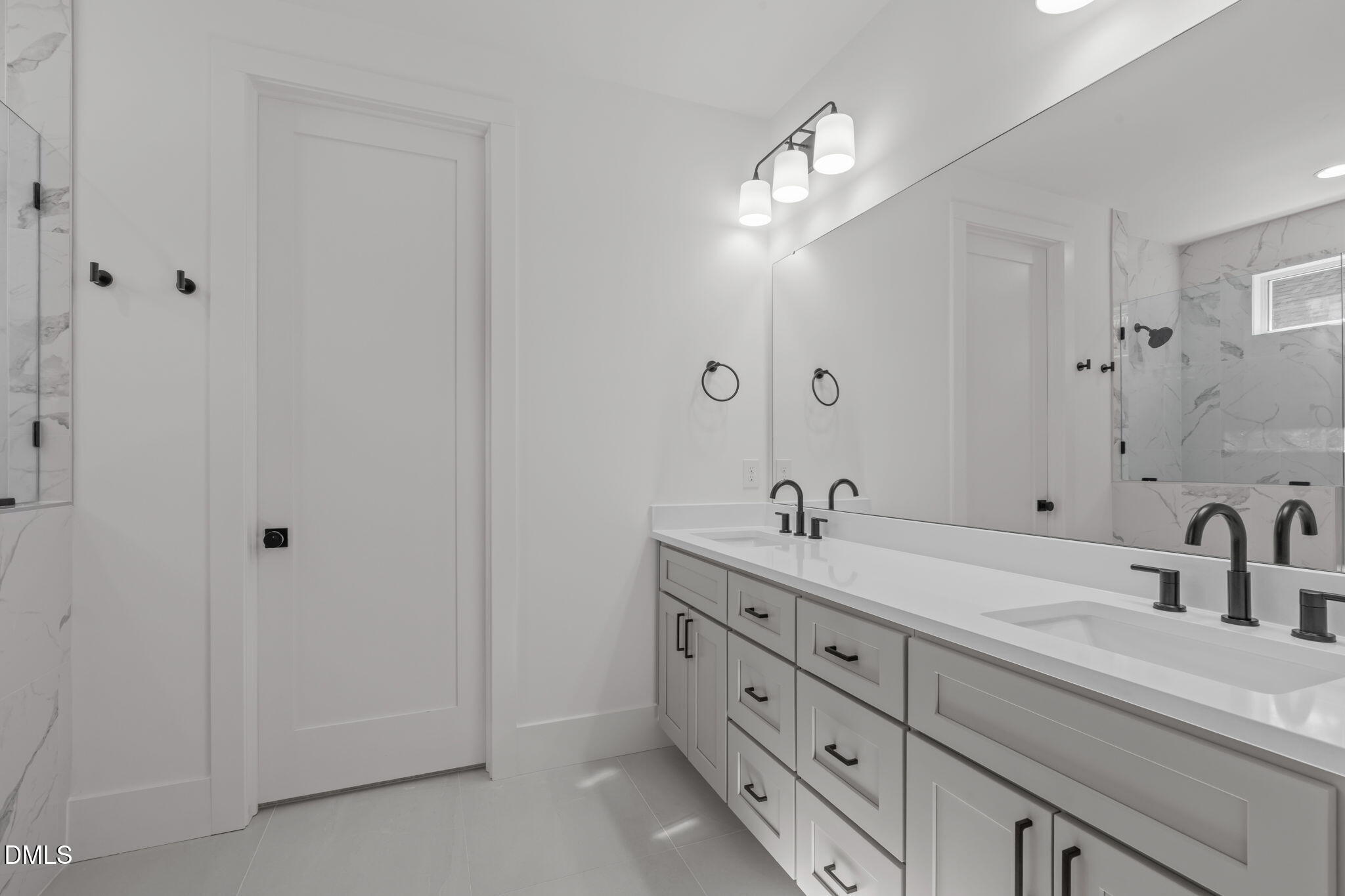 637 Conover Road, Unit B Durham, NC 27703 - Photo 28 of 52 a bathroom with a double vanity sink and a mirror