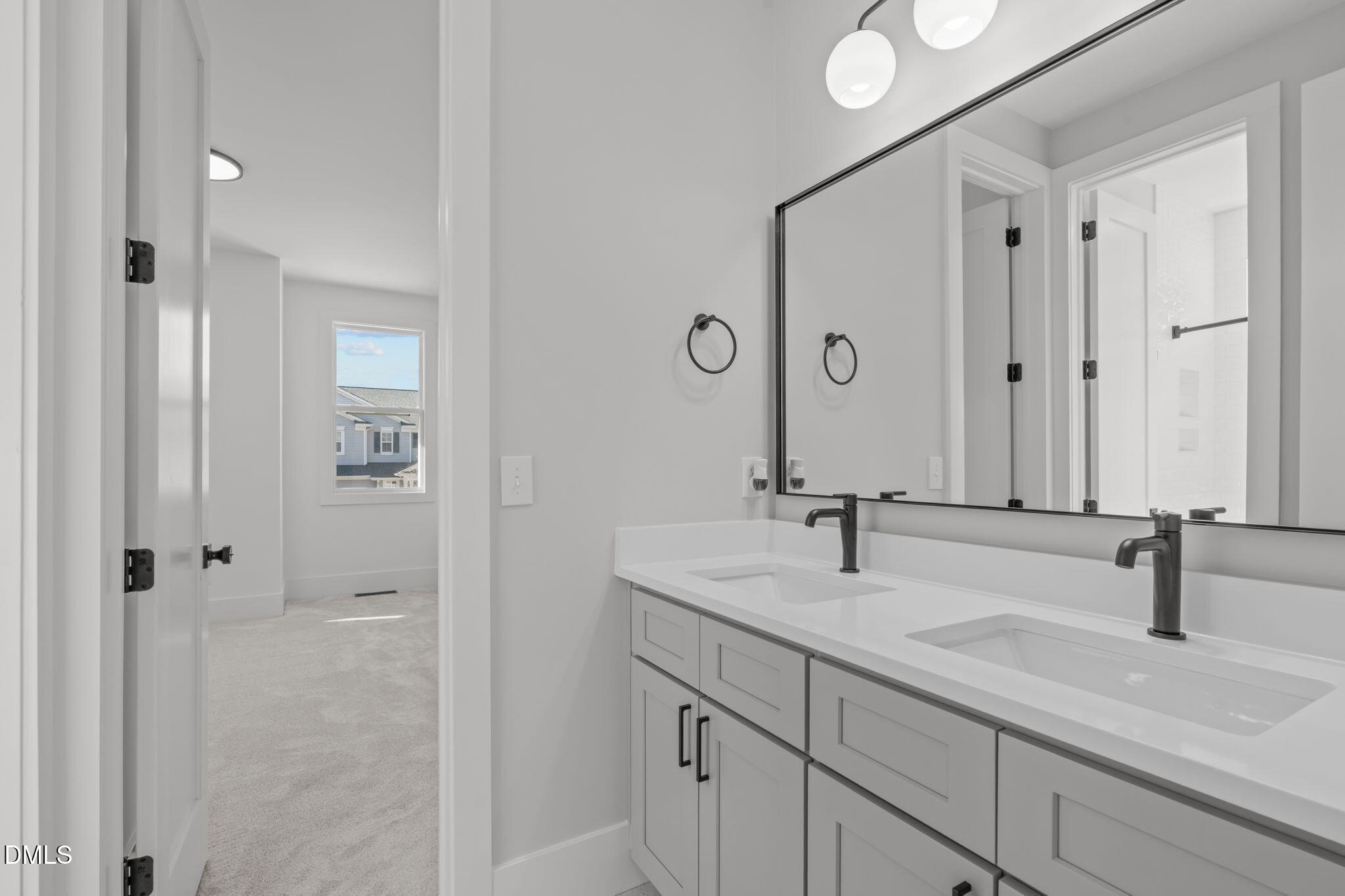 637 Conover Road, Unit B Durham, NC 27703 - Photo 38 of 52 a bathroom with double sink and mirror