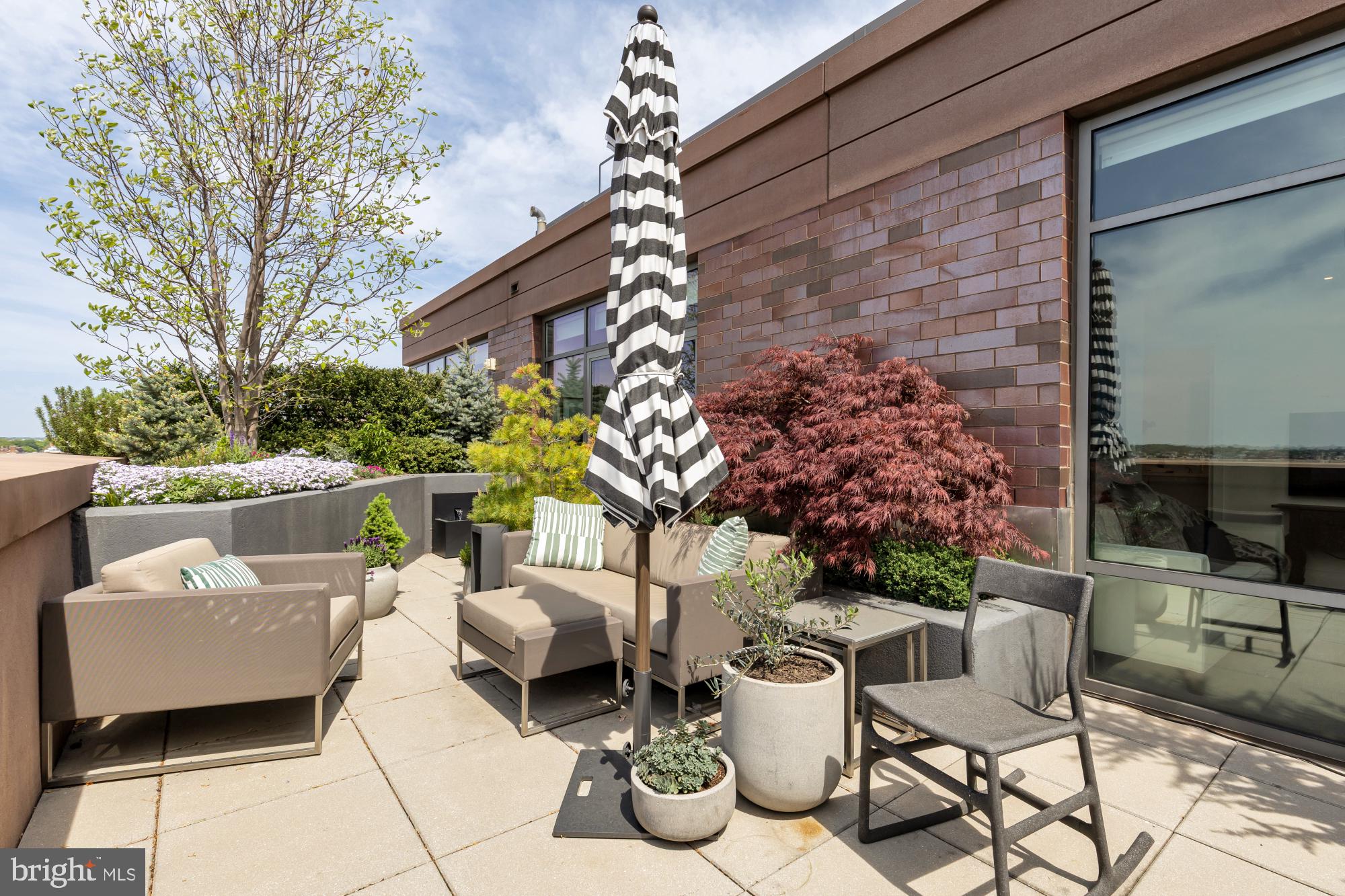 810 O Street Northwest, Unit 901 Washington, DC 20001 - Photo 20 of 38 a view of a patio with couches table and chairs and potted plants