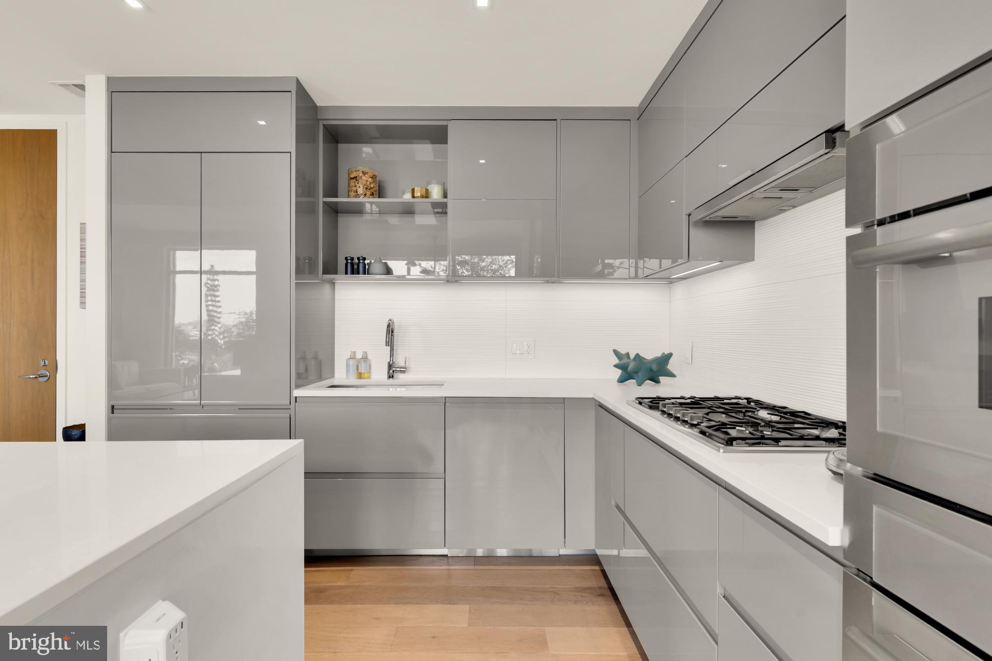 810 O Street Northwest, Unit 901 Washington, DC 20001 - Photo 10 of 38 a kitchen with stainless steel appliances a sink and cabinets