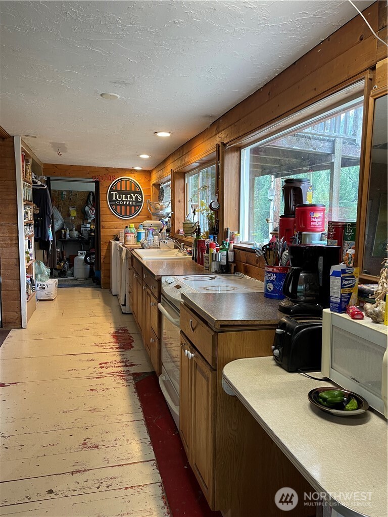 57 Slippery Hill Lane Republic, WA 99166 - Photo 12 of 32 a kitchen with a sink and a stove top oven