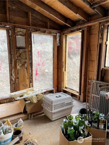 a living room with furniture and a floor to ceiling window