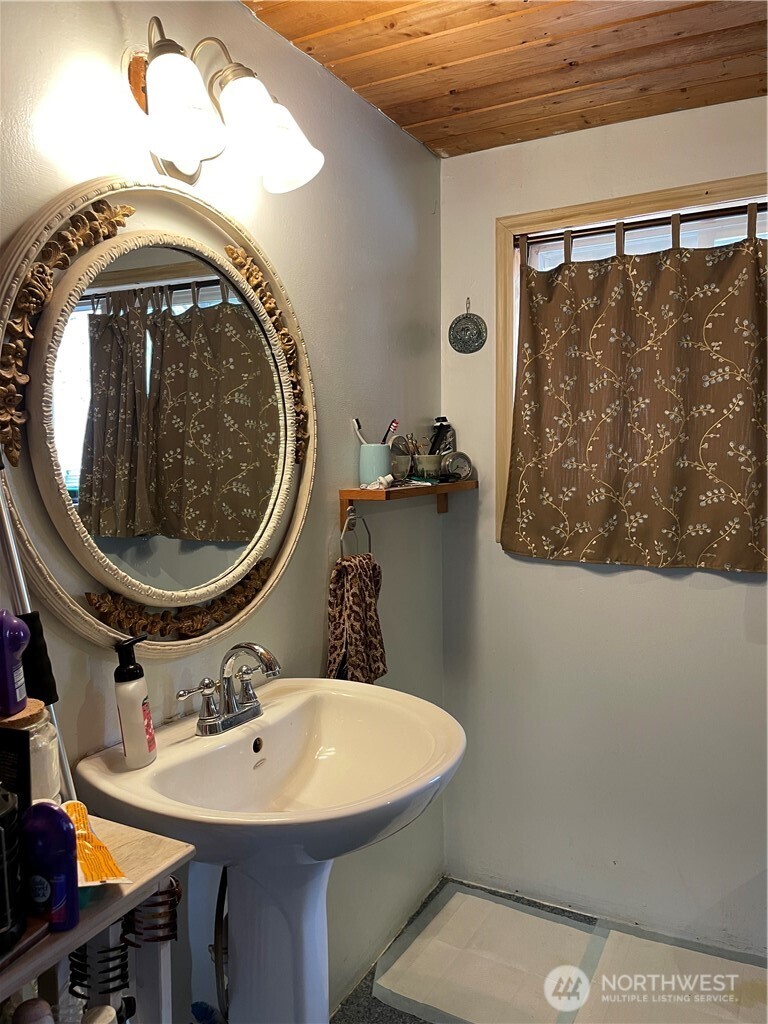 57 Slippery Hill Lane Republic, WA 99166 - Photo 22 of 32 a bathroom with a sink mirror vanity and toilet