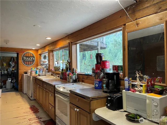a kitchen that has a lot of cabinets and a refrigerator
