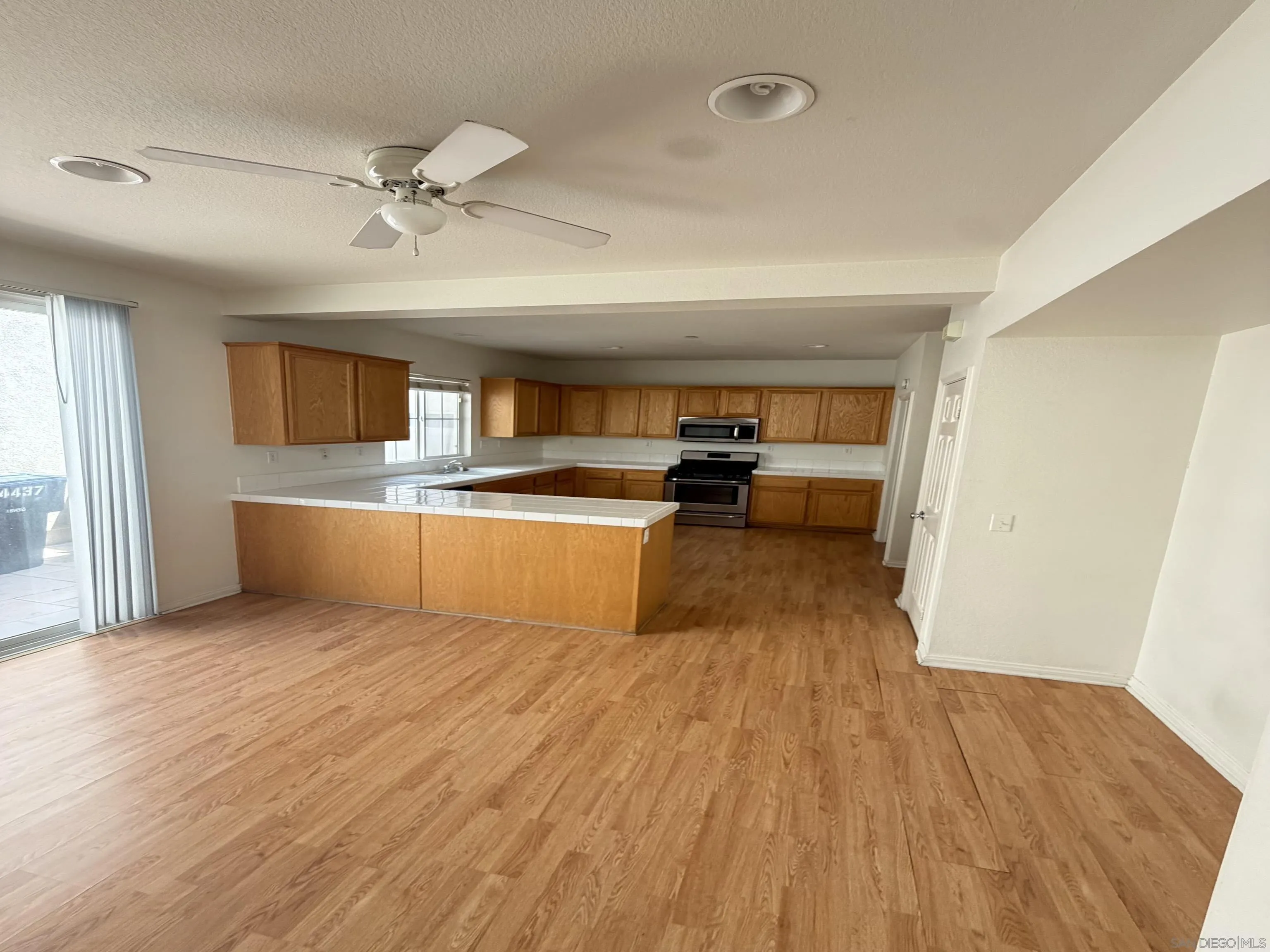 4437 Leonard Court Riverside, CA 92501 - Photo 1 of 6 a view of a kitchen with wooden floor and electronic appliances