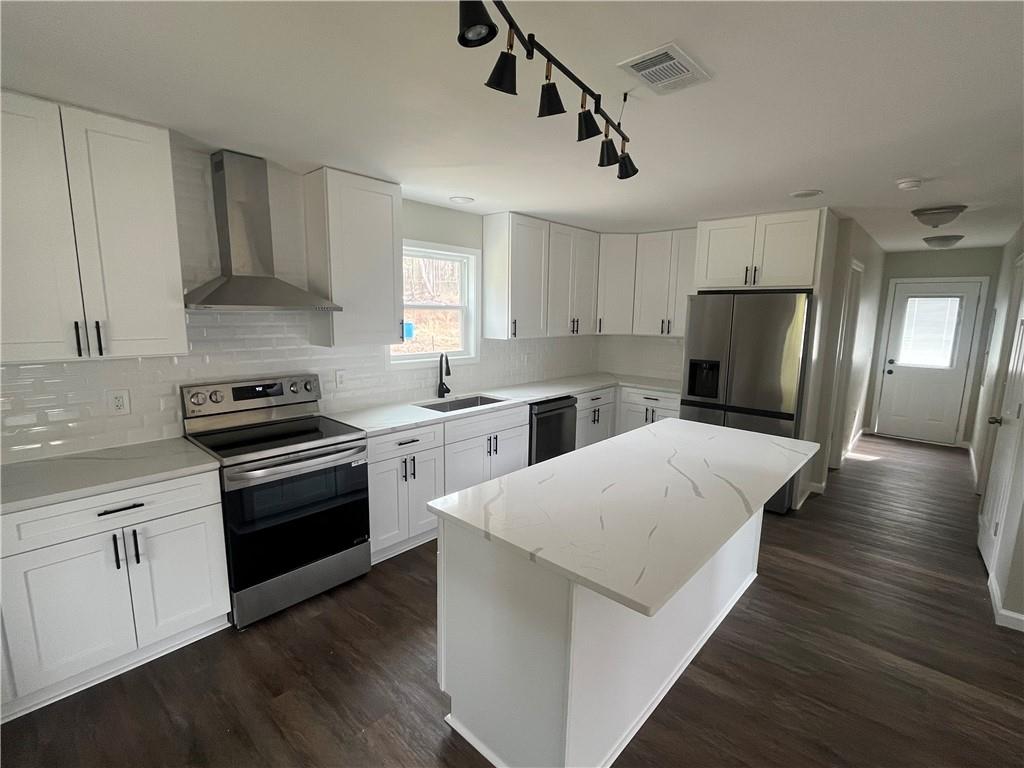 151 Richardson Street Toccoa, GA 30577 - Photo 12 of 48 a kitchen with granite countertop a refrigerator stove top oven and sink