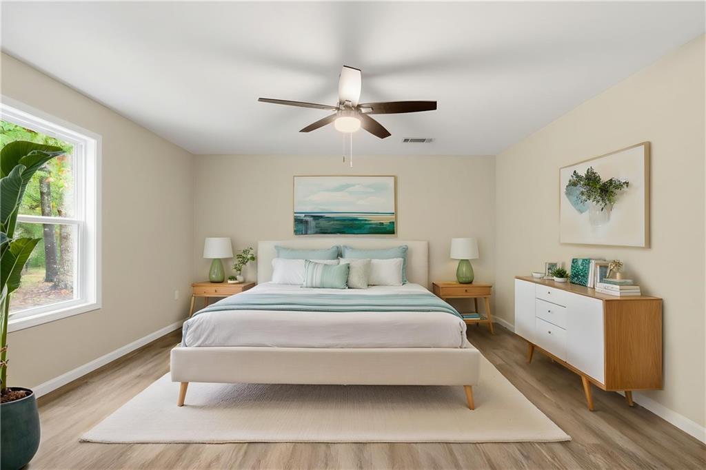 151 Richardson Street Toccoa, GA 30577 - Photo 19 of 48 a bedroom with a large bed and a chandelier