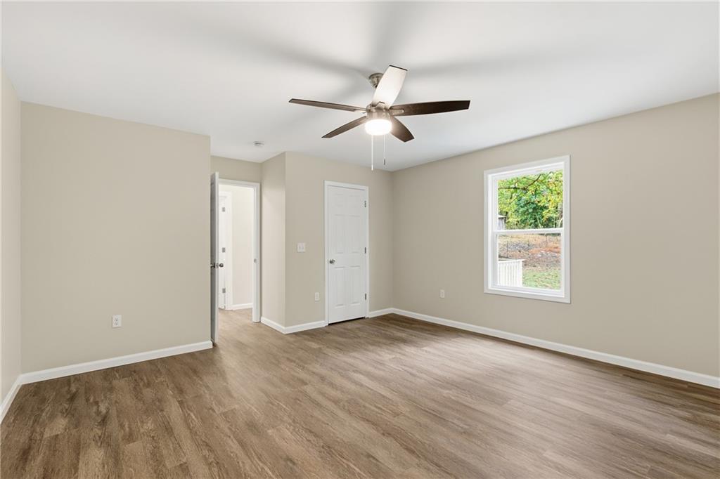 151 Richardson Street Toccoa, GA 30577 - Photo 20 of 48 a view of empty room with wooden floor and fan