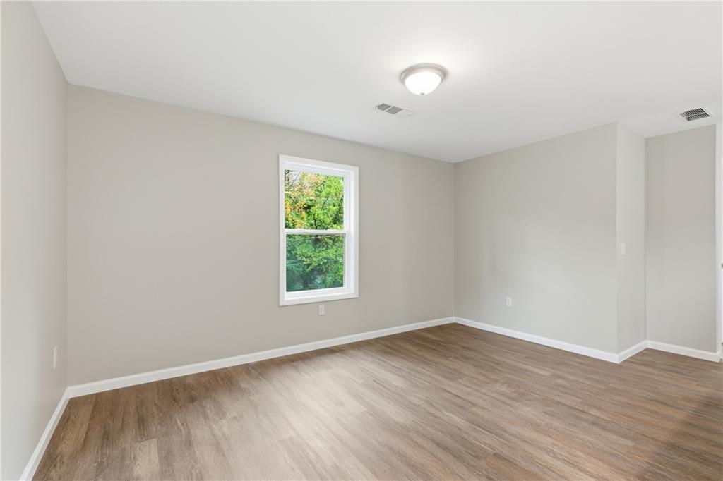 151 Richardson Street Toccoa, GA 30577 - Photo 22 of 48 an empty room with wooden floor and windows
