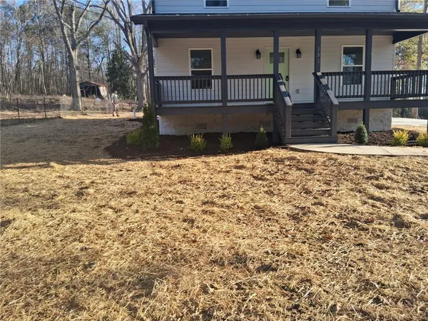 a front view of a house with garden