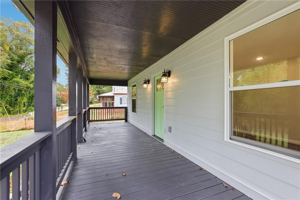 151 Richardson Street Toccoa, GA 30577 - Photo 8 of 48 a view of a porch with wooden floor and windows