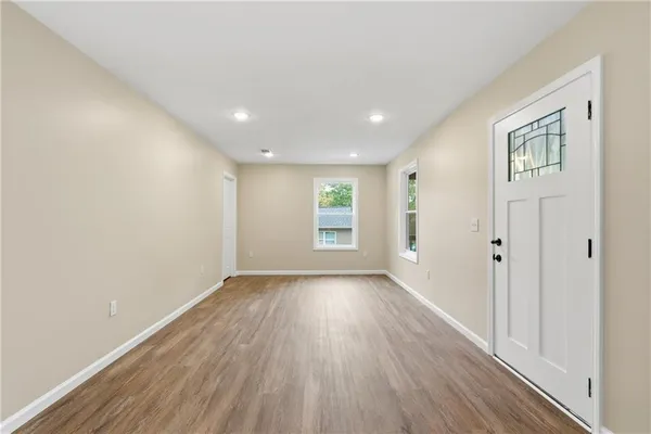 a kitchen with granite countertop a refrigerator stove top oven and sink