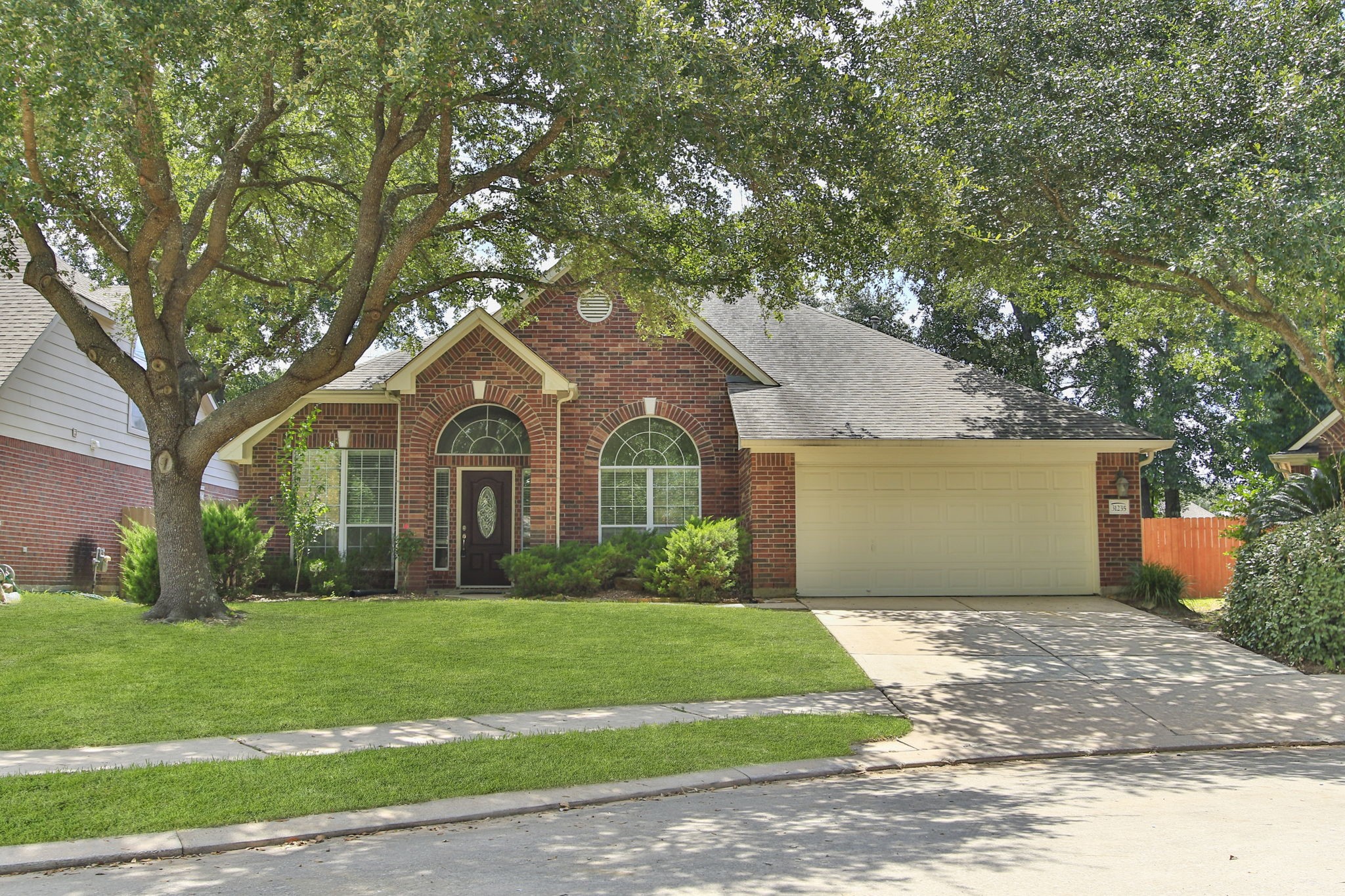 31235 Windcrest Park Lane Spring, TX 77386 - Photo 1 of 50 a front view of house with yard and green space