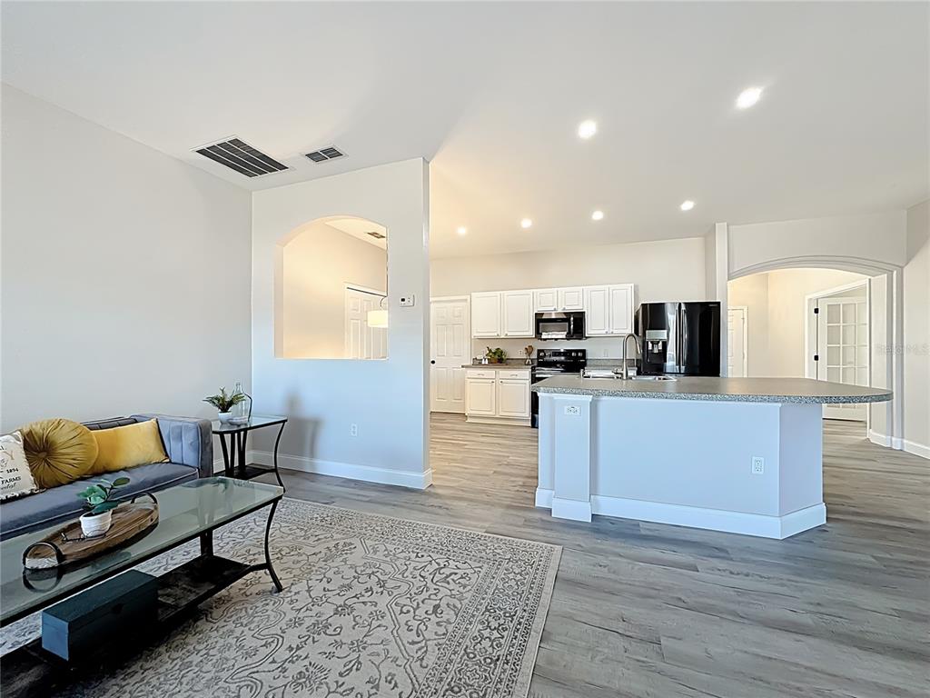 312 Towhee Road Winter Haven, FL 33881 - Photo 14 of 45 a view of kitchen with cabinets stainless steel appliances and wooden floor