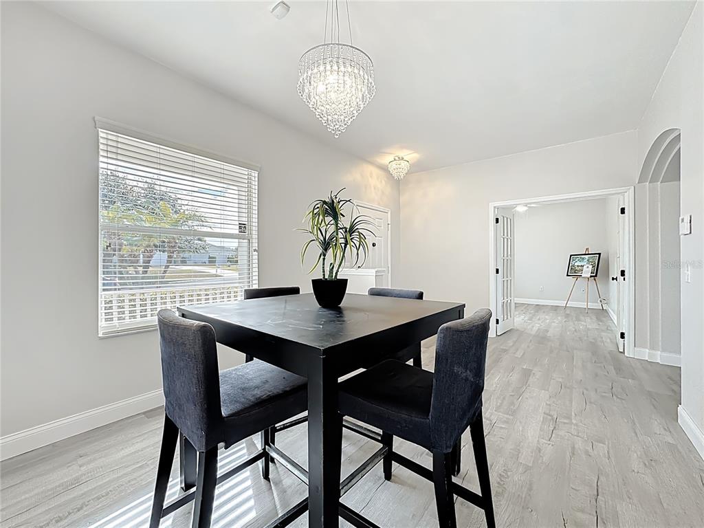 312 Towhee Road Winter Haven, FL 33881 - Photo 21 of 45 a view of a dining room with furniture window and wooden floor