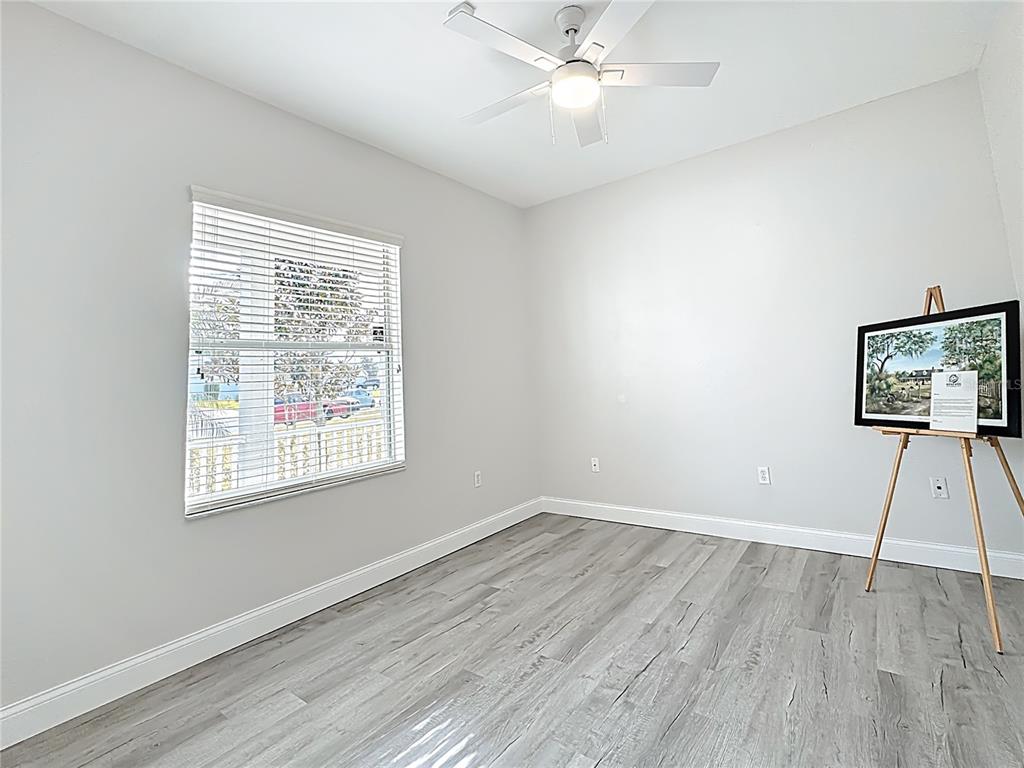 312 Towhee Road Winter Haven, FL 33881 - Photo 23 of 45 a view of an empty room with wooden floor and a window