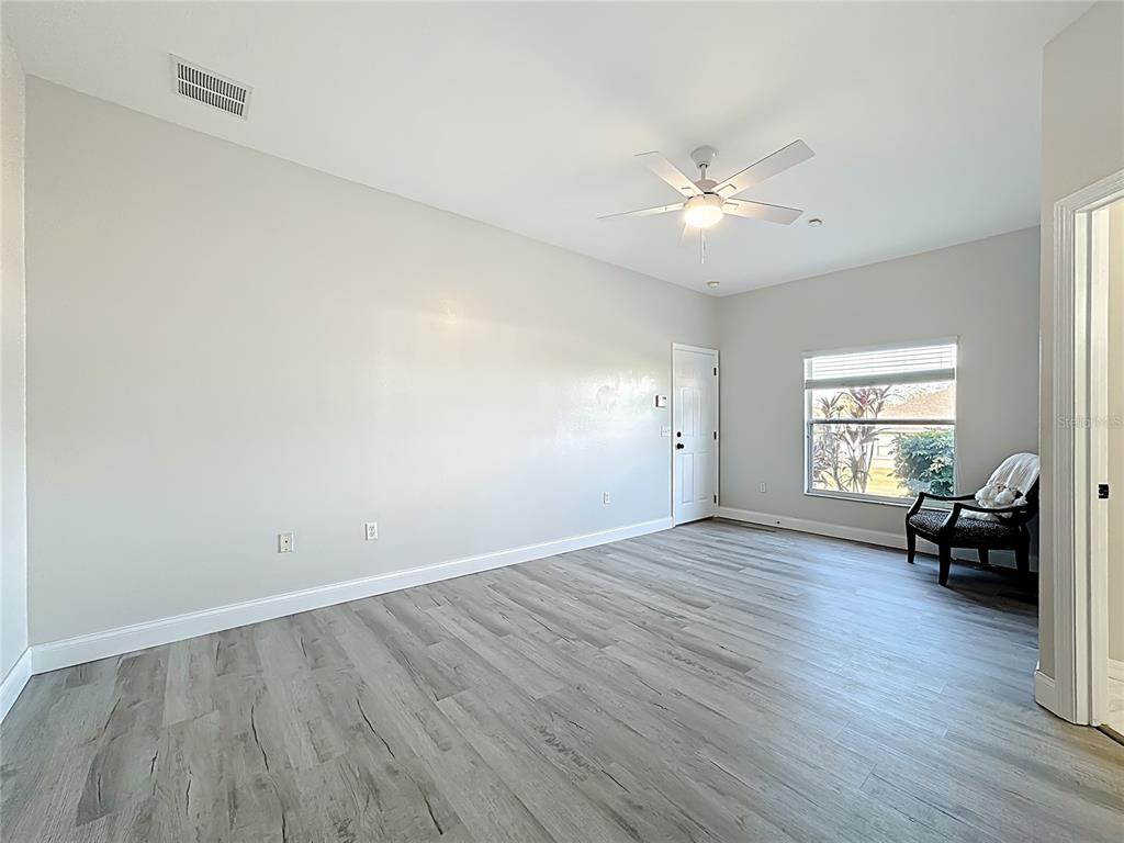 312 Towhee Road Winter Haven, FL 33881 - Photo 27 of 45 an empty room with wooden floor and windows