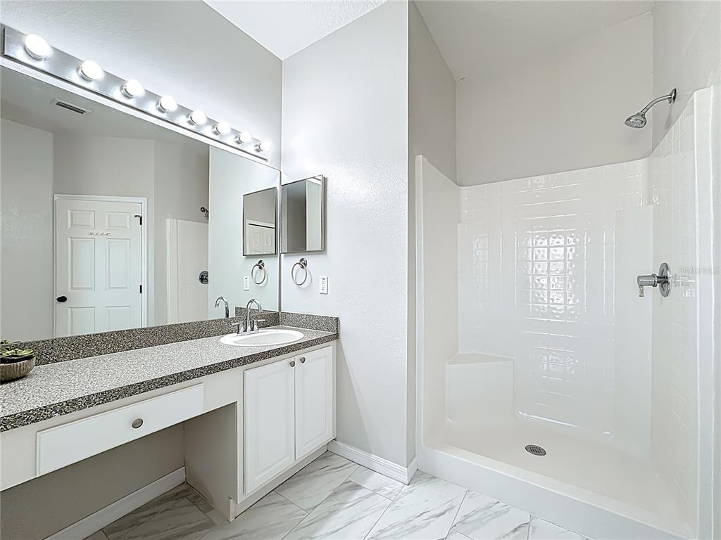 312 Towhee Road Winter Haven, FL 33881 - Photo 29 of 45 a bathroom with a shower sink and mirror