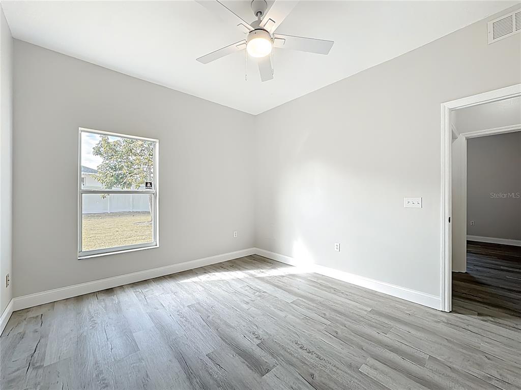 312 Towhee Road Winter Haven, FL 33881 - Photo 32 of 45 a view of an empty room with wooden floor and a window
