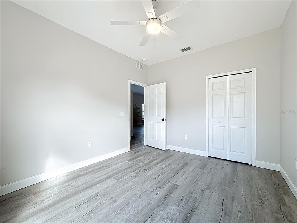 312 Towhee Road Winter Haven, FL 33881 - Photo 33 of 45 an empty room with wooden floor and windows