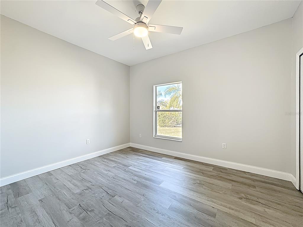 312 Towhee Road Winter Haven, FL 33881 - Photo 34 of 45 wooden floor in an empty room with a window
