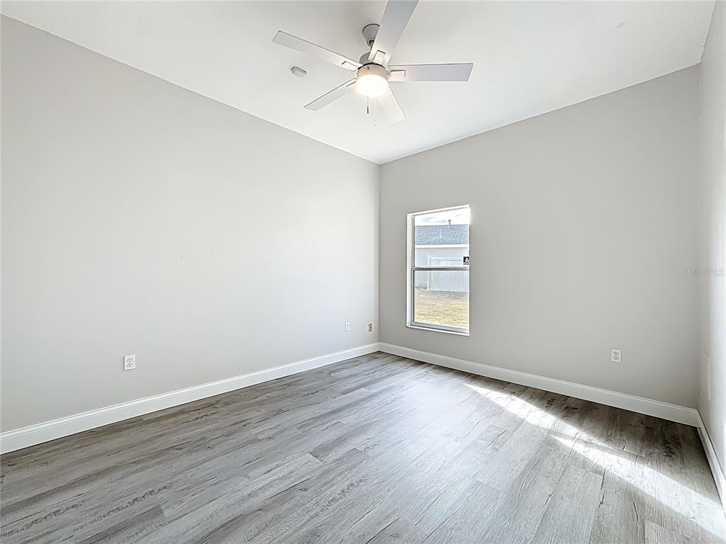 312 Towhee Road Winter Haven, FL 33881 - Photo 35 of 45 wooden floor in an empty room with a window