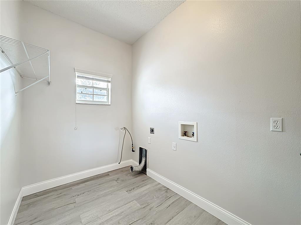 312 Towhee Road Winter Haven, FL 33881 - Photo 38 of 45 an empty room with a wooden floor and a window