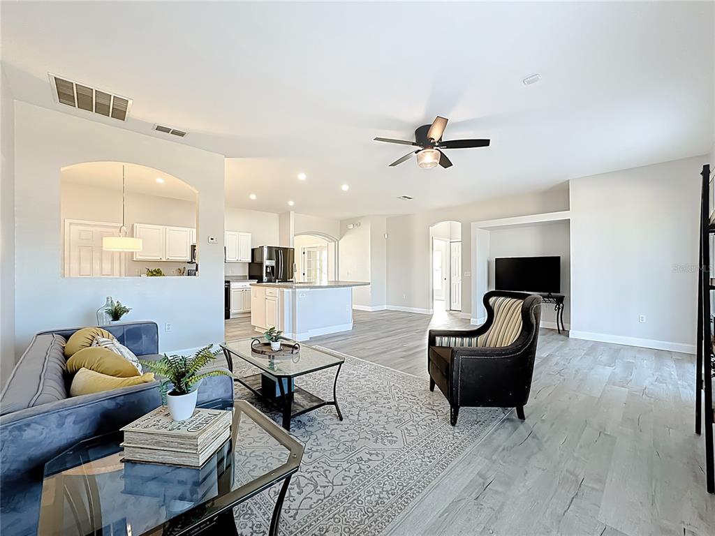 312 Towhee Road Winter Haven, FL 33881 - Photo 7 of 45 a living room with furniture and a chandelier