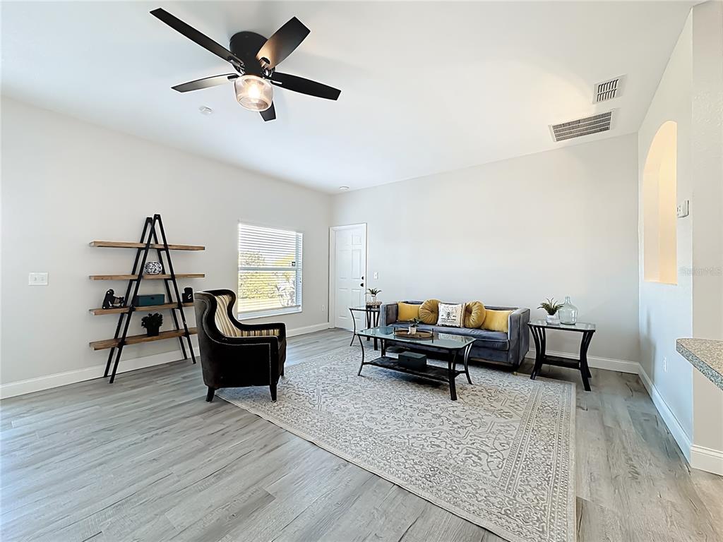 312 Towhee Road Winter Haven, FL 33881 - Photo 10 of 45 a living room with furniture and a wooden floor