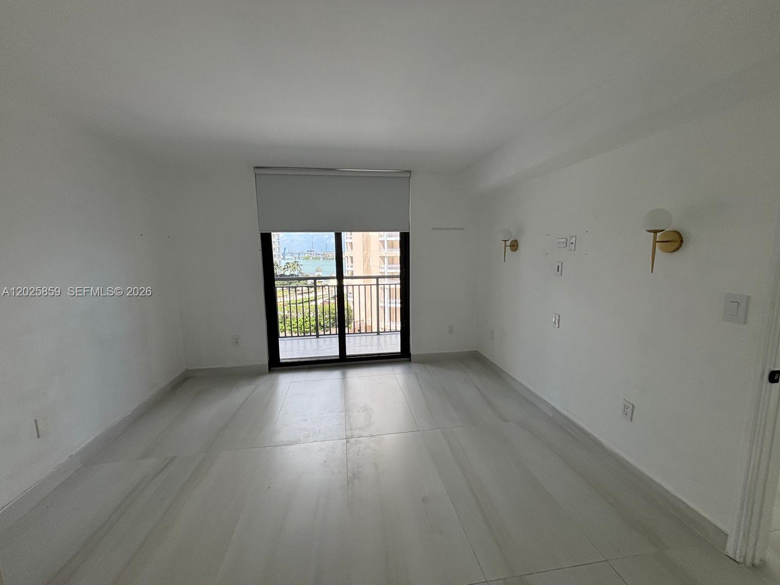 540 Brickell Key Drive, Unit 1024 Miami, FL 33131 - Photo 18 of 28 an empty room with wooden floor and windows