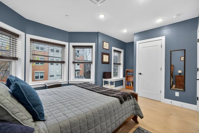a bedroom with a large bed and a large window