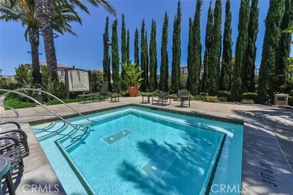 a swimming pool with outdoor seating and yard