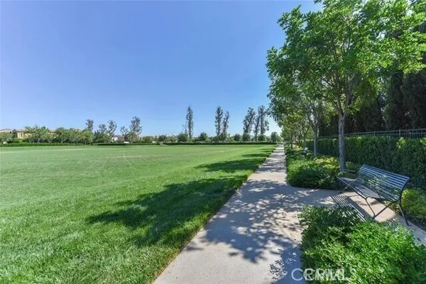 a view of a park with a house in the background