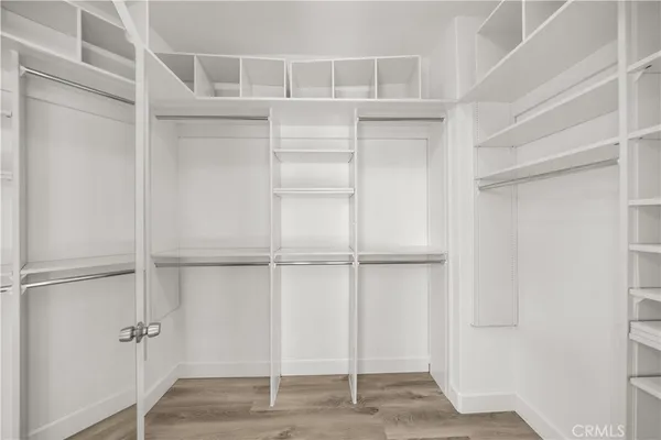a view of walk in closet with empty racks