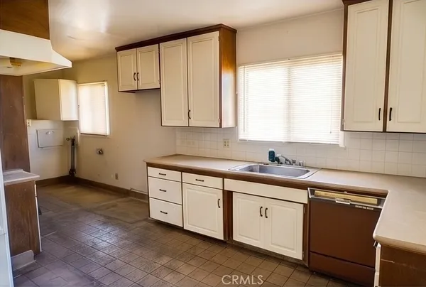 a kitchen with a sink cabinets and window