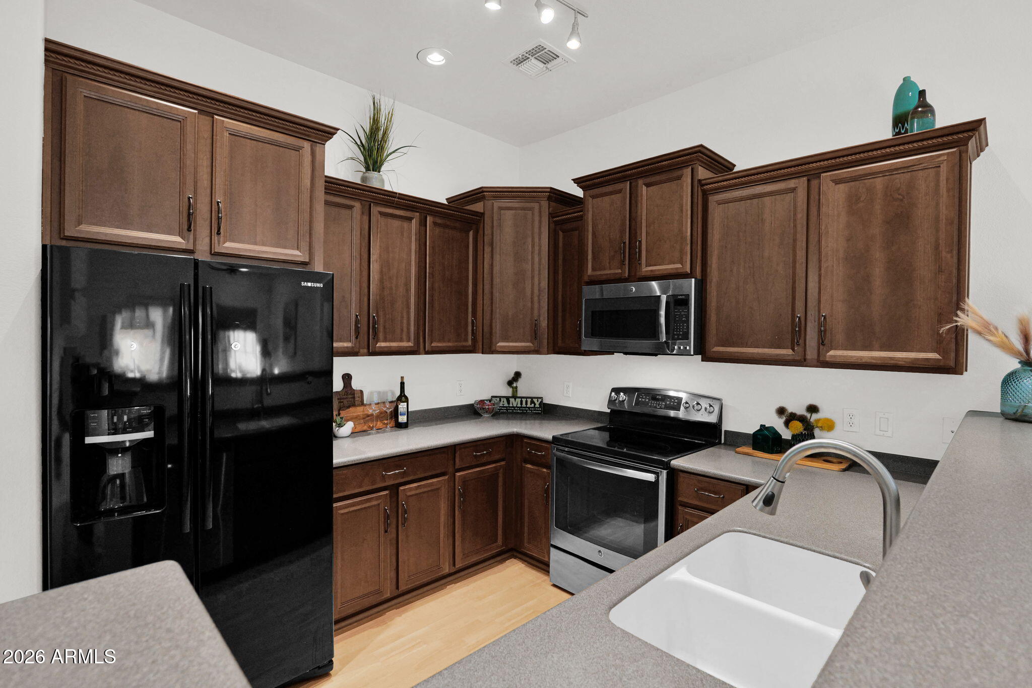 2402 East 5th Street, Unit 1646 Tempe, AZ 85288 - Photo 1 of 37 a kitchen with granite countertop a refrigerator stove and sink