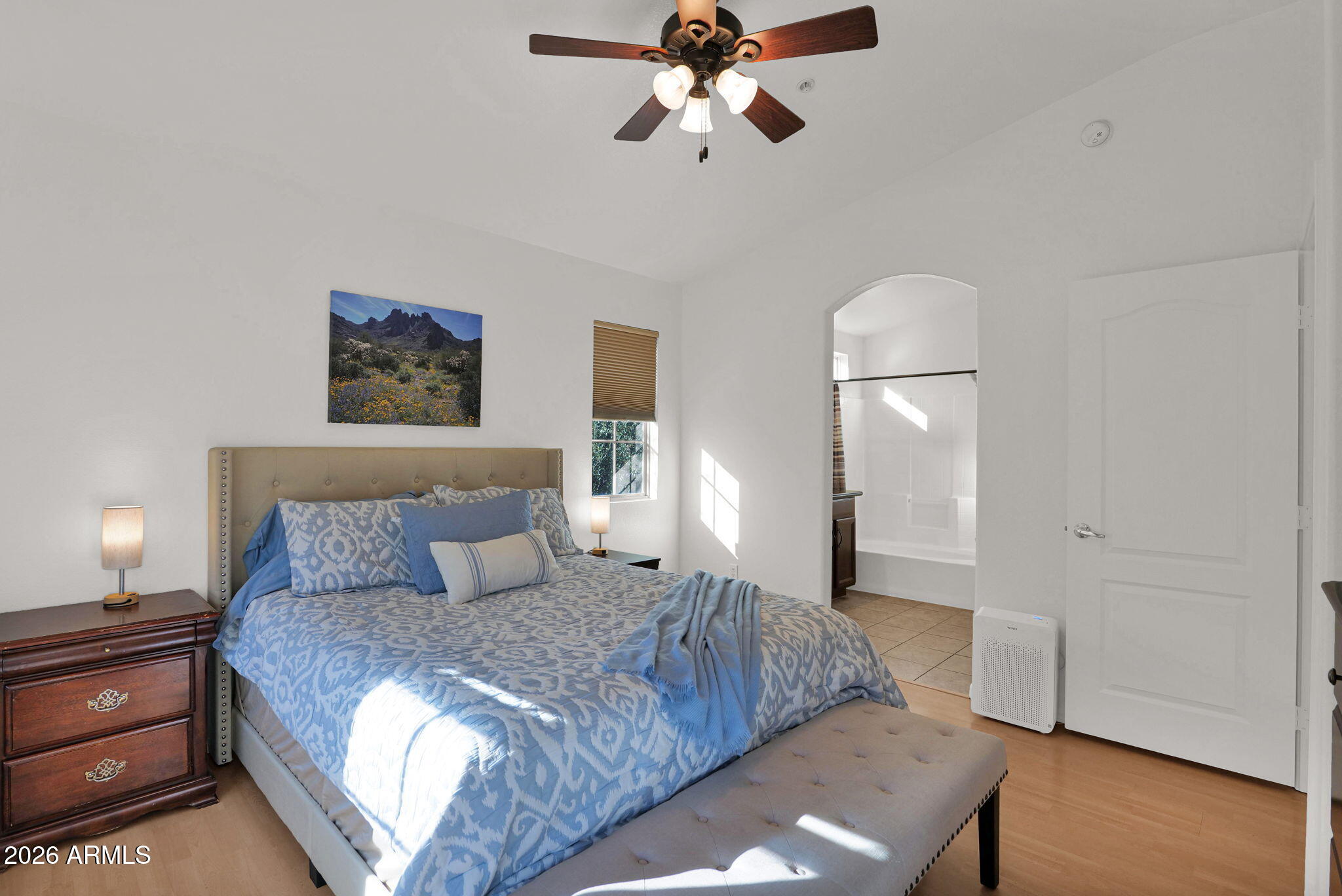 2402 East 5th Street, Unit 1646 Tempe, AZ 85288 - Photo 13 of 37 a bedroom with a large bed and a chandelier