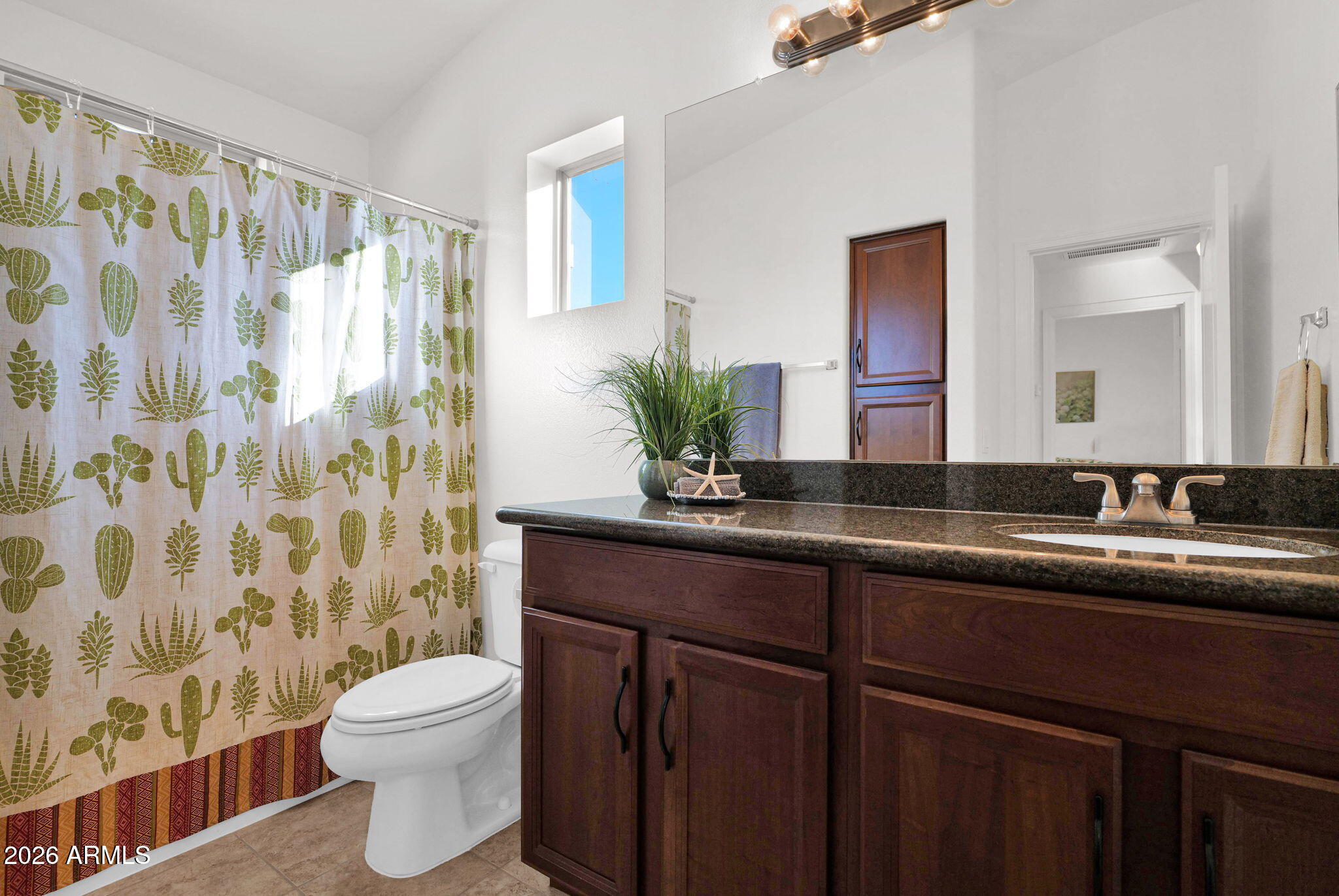 2402 East 5th Street, Unit 1646 Tempe, AZ 85288 - Photo 18 of 37 a bathroom with a granite countertop sink a toilet and a mirror