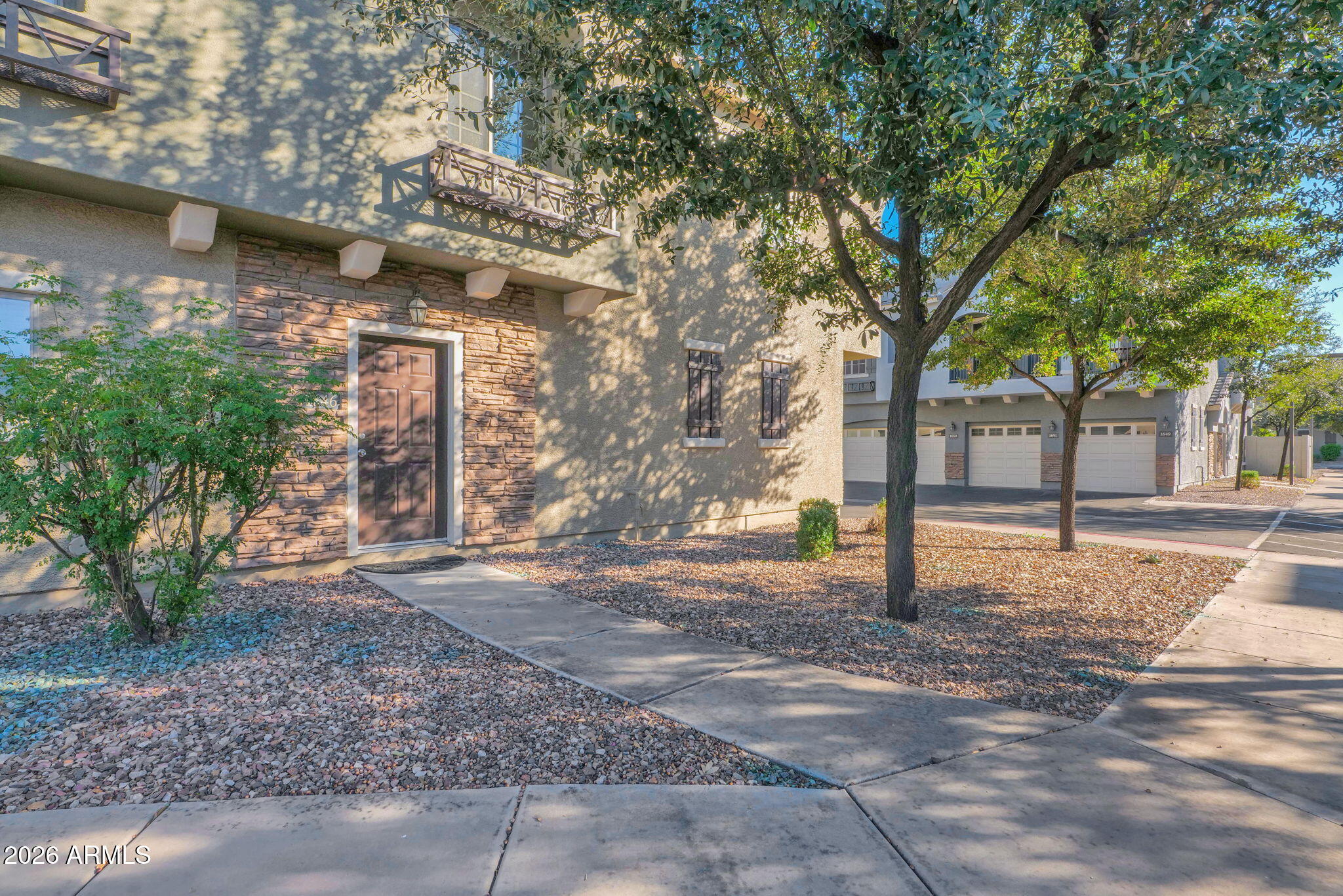 2402 East 5th Street, Unit 1646 Tempe, AZ 85288 - Photo 24 of 37 a view of a road with a tree in front of it