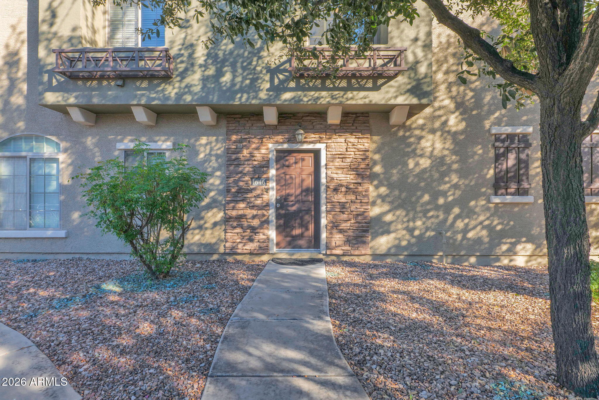 2402 East 5th Street, Unit 1646 Tempe, AZ 85288 - Photo 25 of 37 a view of a pathway of a house with a yard and a fountain