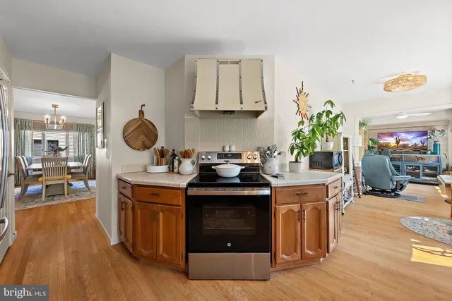 a kitchen with stainless steel appliances granite countertop sink stove top oven and cabinets