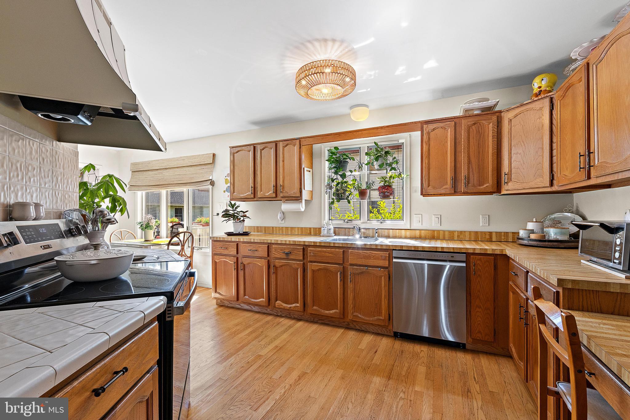 37 Fir Road Manahawkin, NJ 08050 - Photo 13 of 40 a kitchen with stainless steel appliances granite countertop sink stove top oven and cabinets