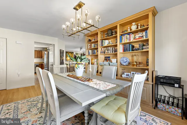 a living room with furniture and a book shelf