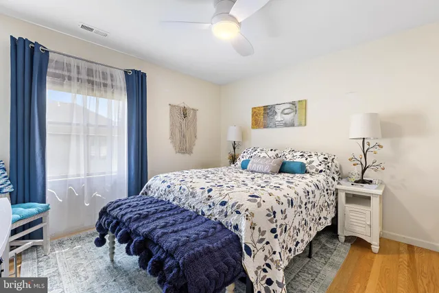 a bedroom with a bed and a dresser with rug