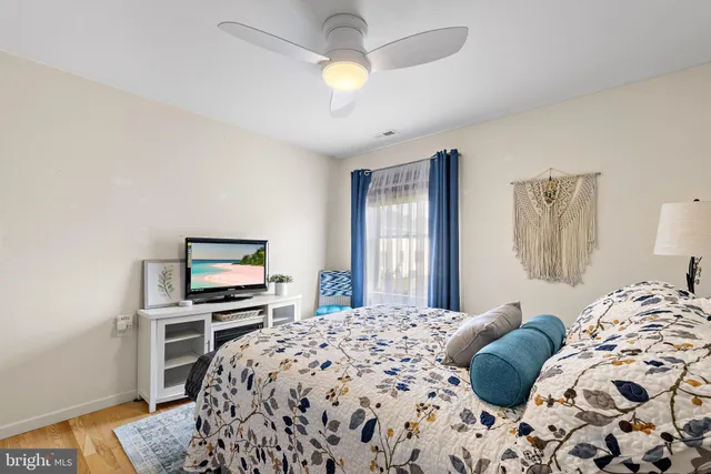 a bedroom with a large bed and a window