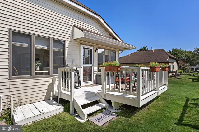 a view of a patio with a table chairs and a barbeque